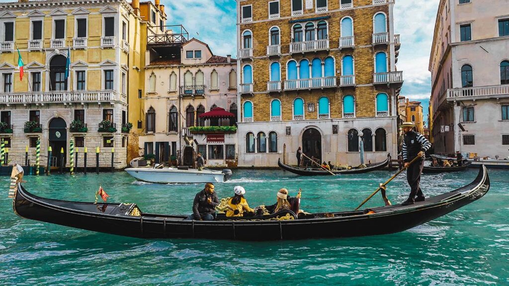 Gondola ride through Venice canals with historic buildings in the background